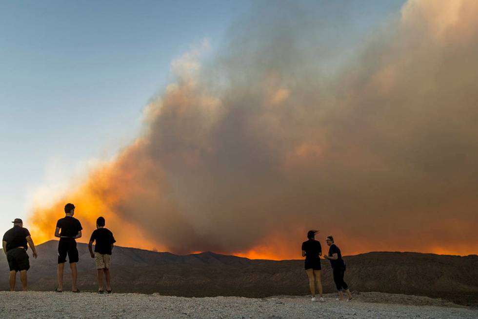 Onlookers stop to view the Mahogany Fire on Mount Charleston near a rise about Harris Spring Ro ...