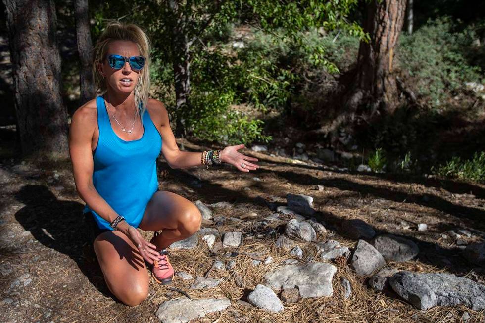 Stephanie Ibasco points out an illegal fire pit on a trail at Mount Charleston on Tuesday, July ...