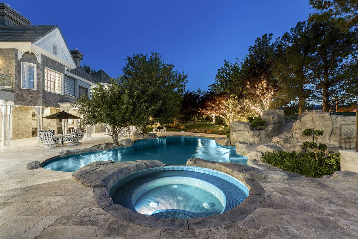 The Queensridge mansion has mature landscaping and pool and spa. (Tom Love Group)