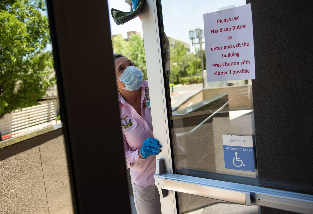 A member of the janitorial staff cleans the entry way on the second day of the 31st Special Ses ...