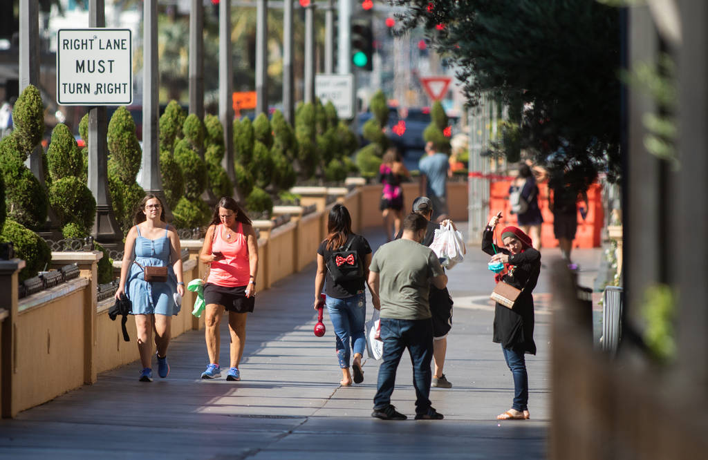 People walk down the Strip in Las Vegas on Friday, July 3, 2020. (Chris Day/Las Vegas Review-Jo ...