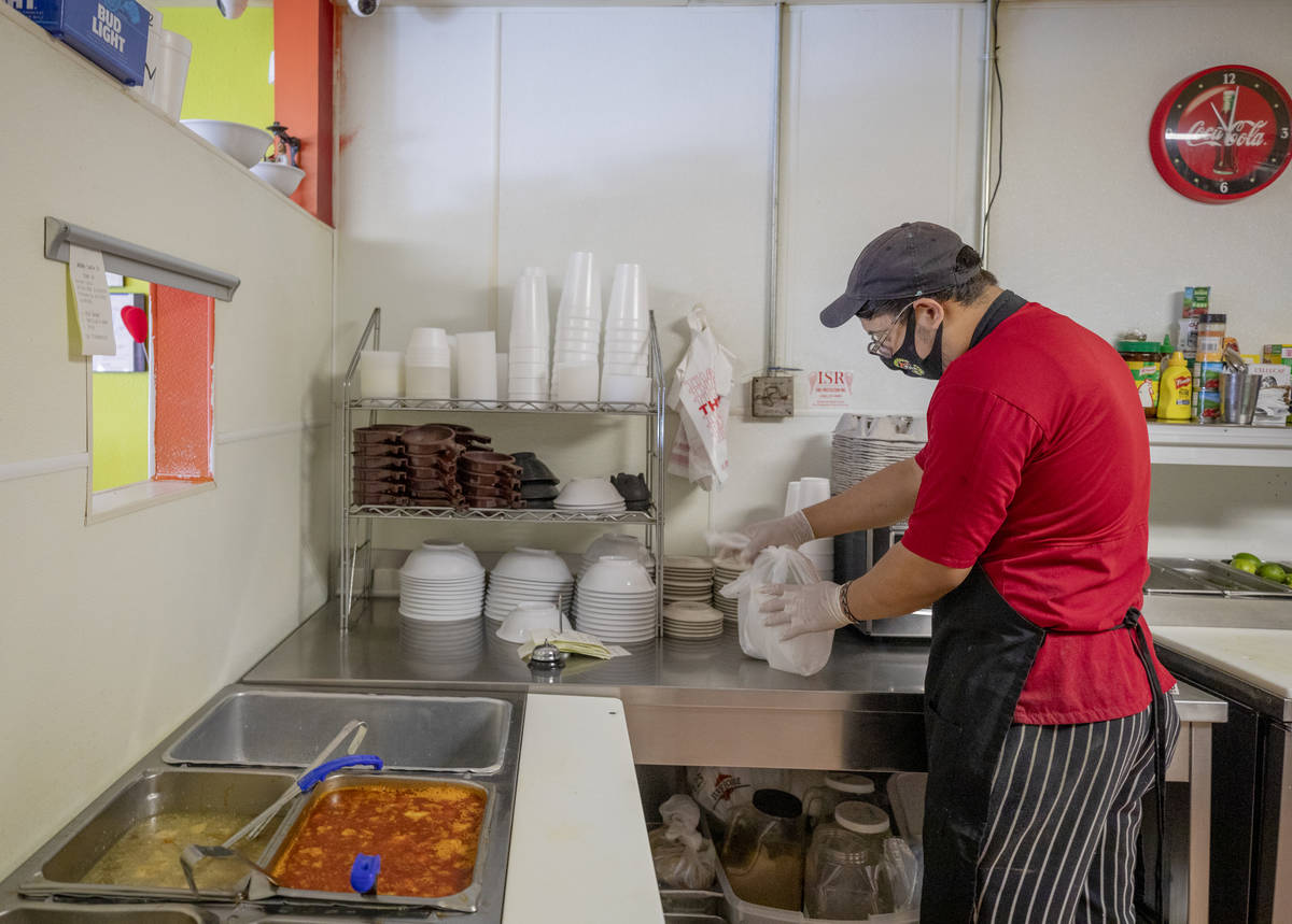 El Menudazo cook Carlos Orduno fulfills a to-go order at the restaurant in North Las Vegas on F ...