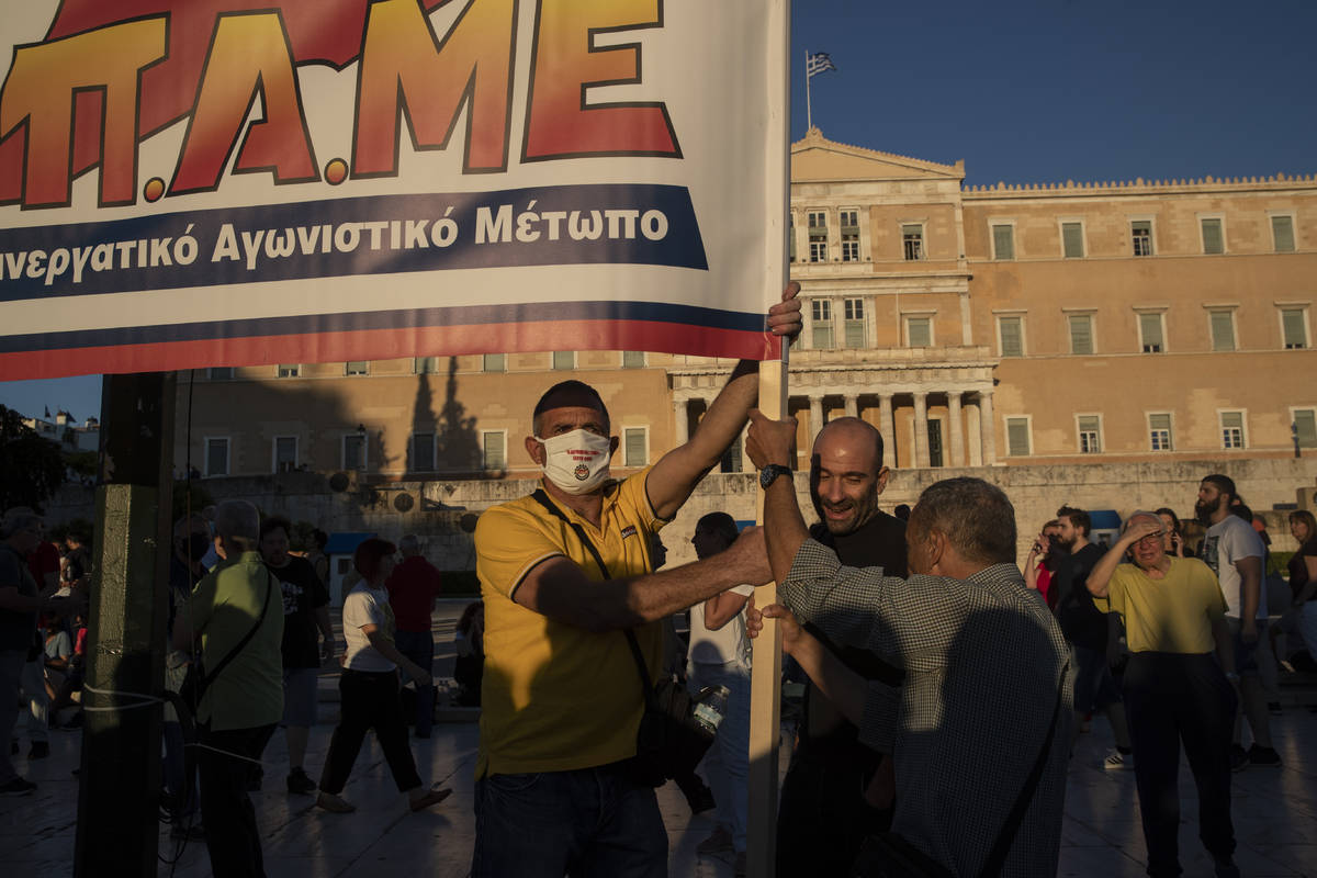 Protesters from the communist party-affiliated PAME union take part in a demonstration outside ...