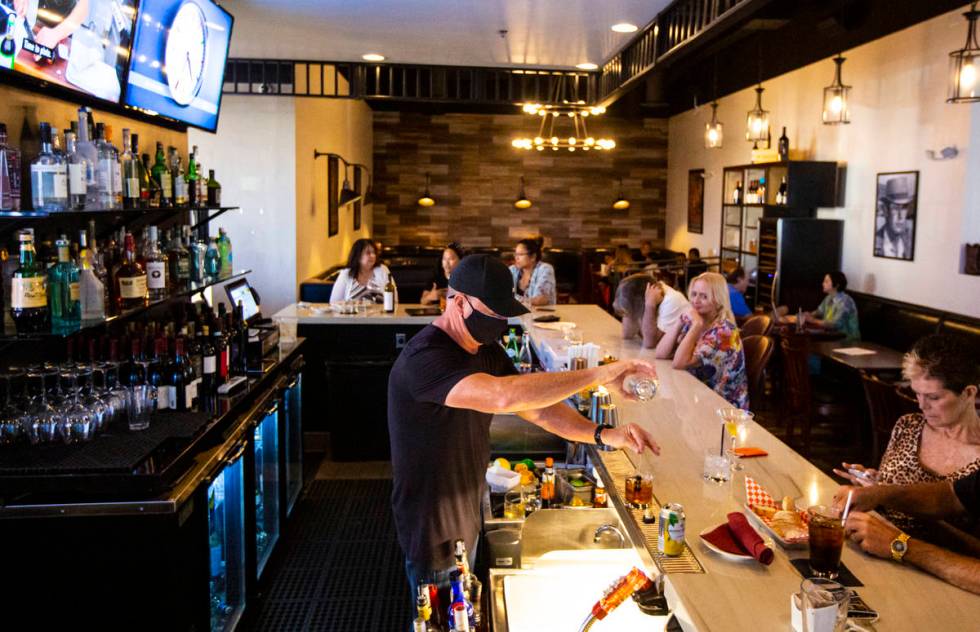 Bar manager David Cooper prepares a drink during happy hour at Spaghetty Western in the Souther ...