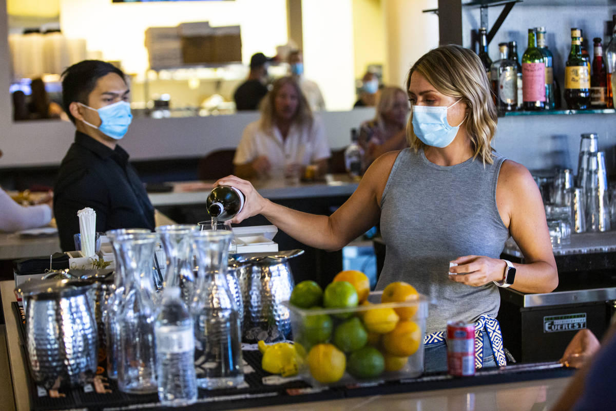 Crystal Falk, bar "ninja" at Spaghetty Western, pours a drink prepares a drink during ...