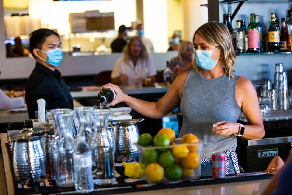 Crystal Falk, bar "ninja" at Spaghetty Western, pours a drink prepares a drink during ...