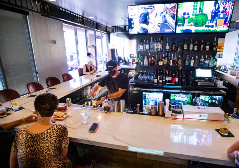 Bar manager David Cooper prepares a drink during happy hour at Spaghetty Western in the Souther ...