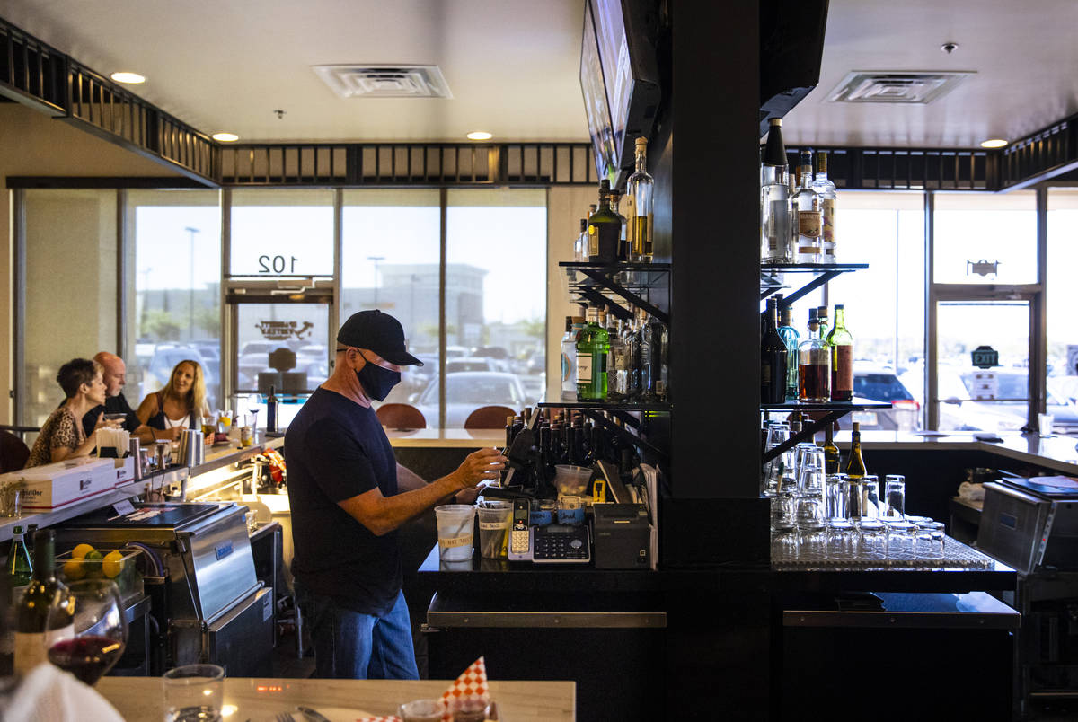 Bar manager David Cooper works during happy hour at Spaghetty Western in the Southern Highlands ...