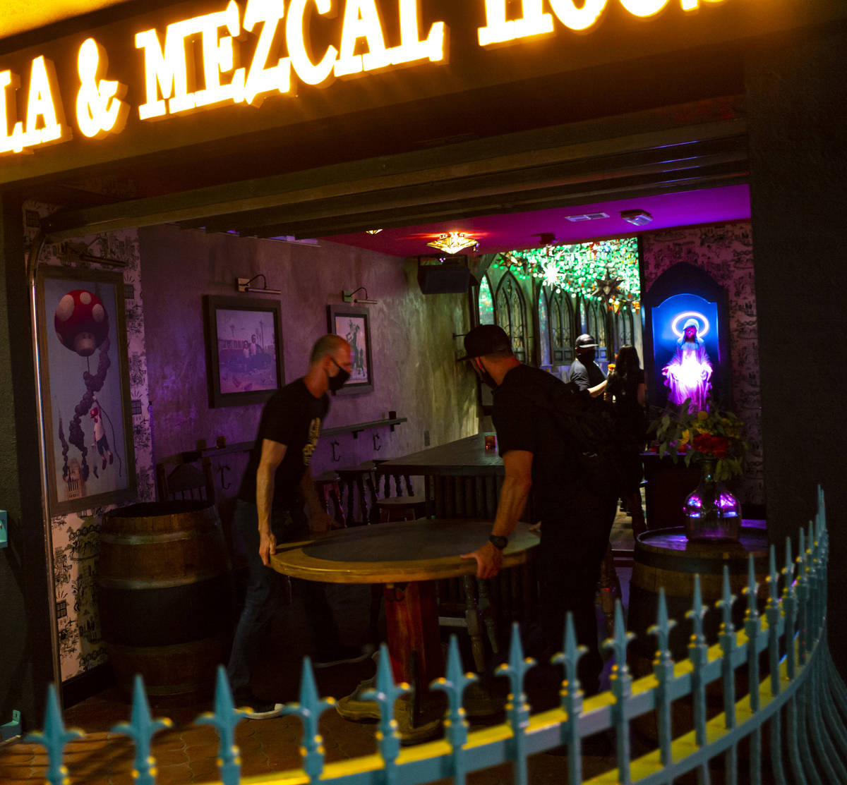 Employees move a table as they shut down at Lucky Day Tequila and & Mezcal House on Fremont ...