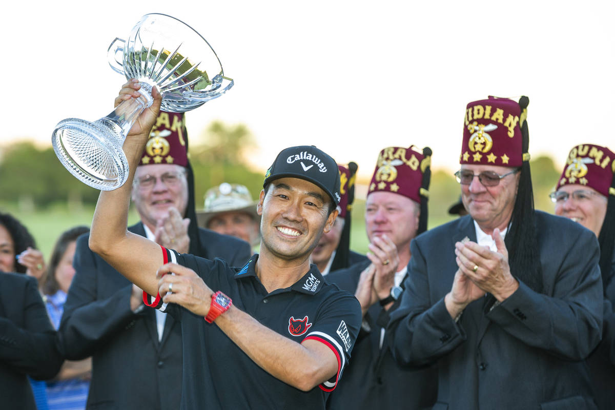 Kevin Na, center, holds up his trophy after winning the tournament at the final round of Shrine ...