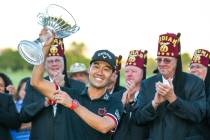 Kevin Na, center, holds up his trophy after winning the tournament at the final round of Shrine ...