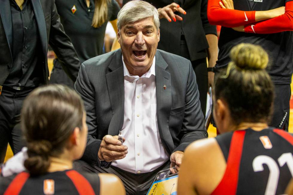 Las Vegas Aces head coach Bill Laimbeer talks up his players in a huddle during a timeout as th ...