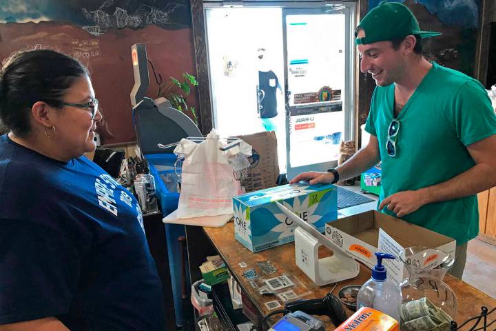 In this photo taken Aug. 25, 2019, Jeremy Keesh, a Burning Man attendee from Chicago, buys coco ...