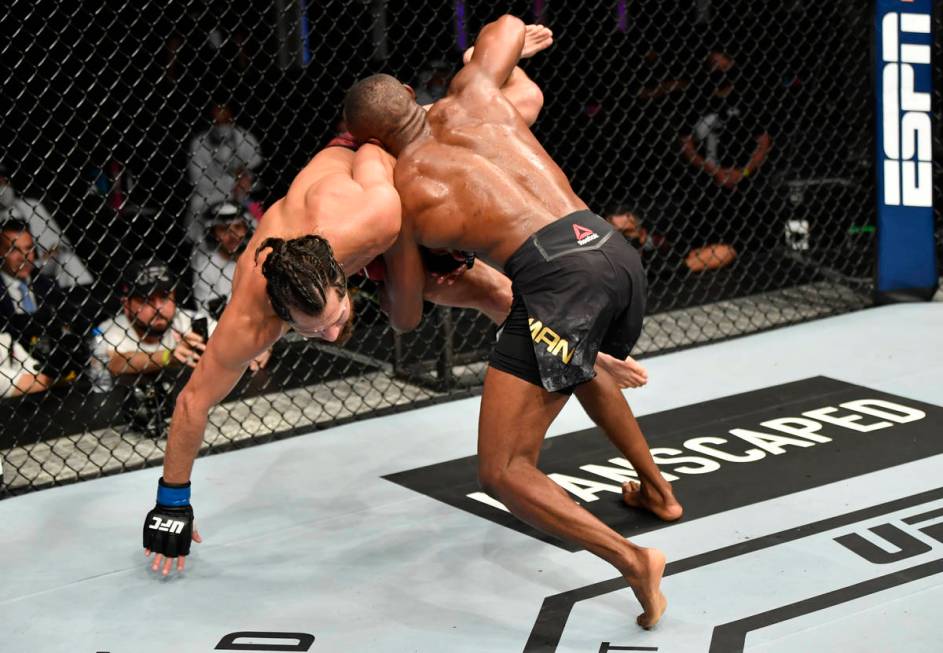 (R-L) Kamaru Usman of Nigeria takes down Jorge Masvidal in their UFC welterweight championship ...