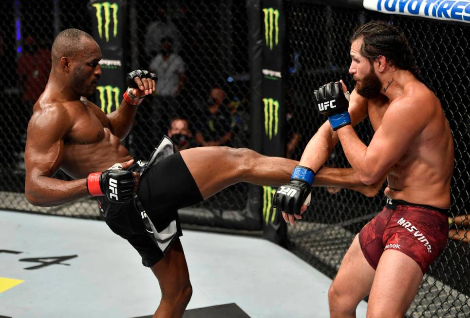 (L-R) Kamaru Usman of Nigeria kicks Jorge Masvidal in their UFC welterweight championship fight ...