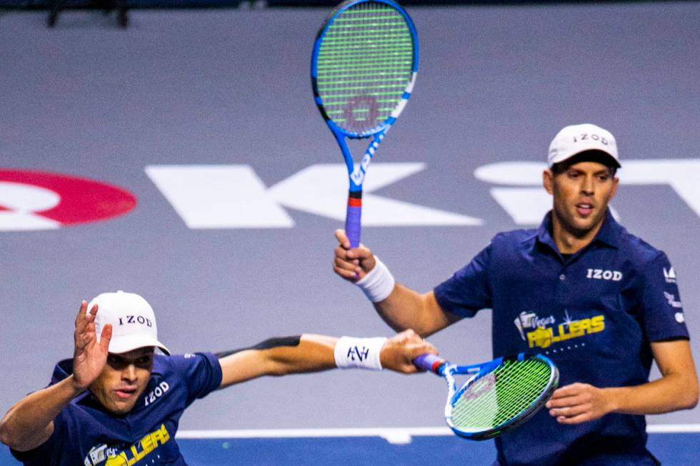 The Vegas Rollers' Bob and Mike Bryan come together after a shot during their men's doubles set ...