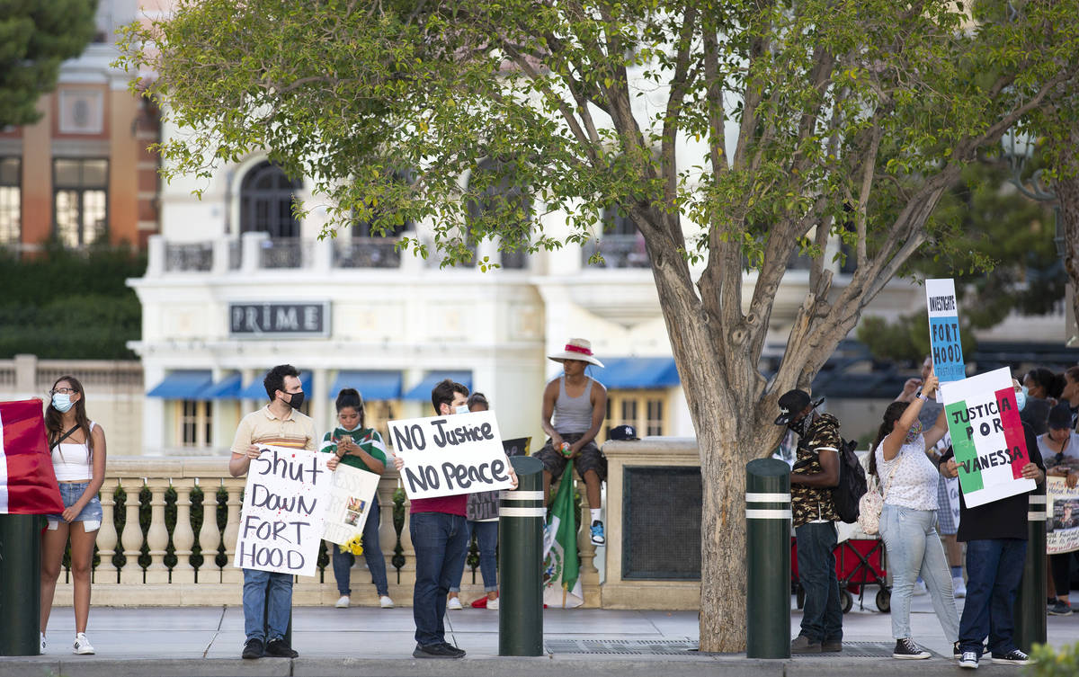 A protest for Vanessa Guillen stops at the Fountains of Bellagio, holding signs to oncoming tra ...