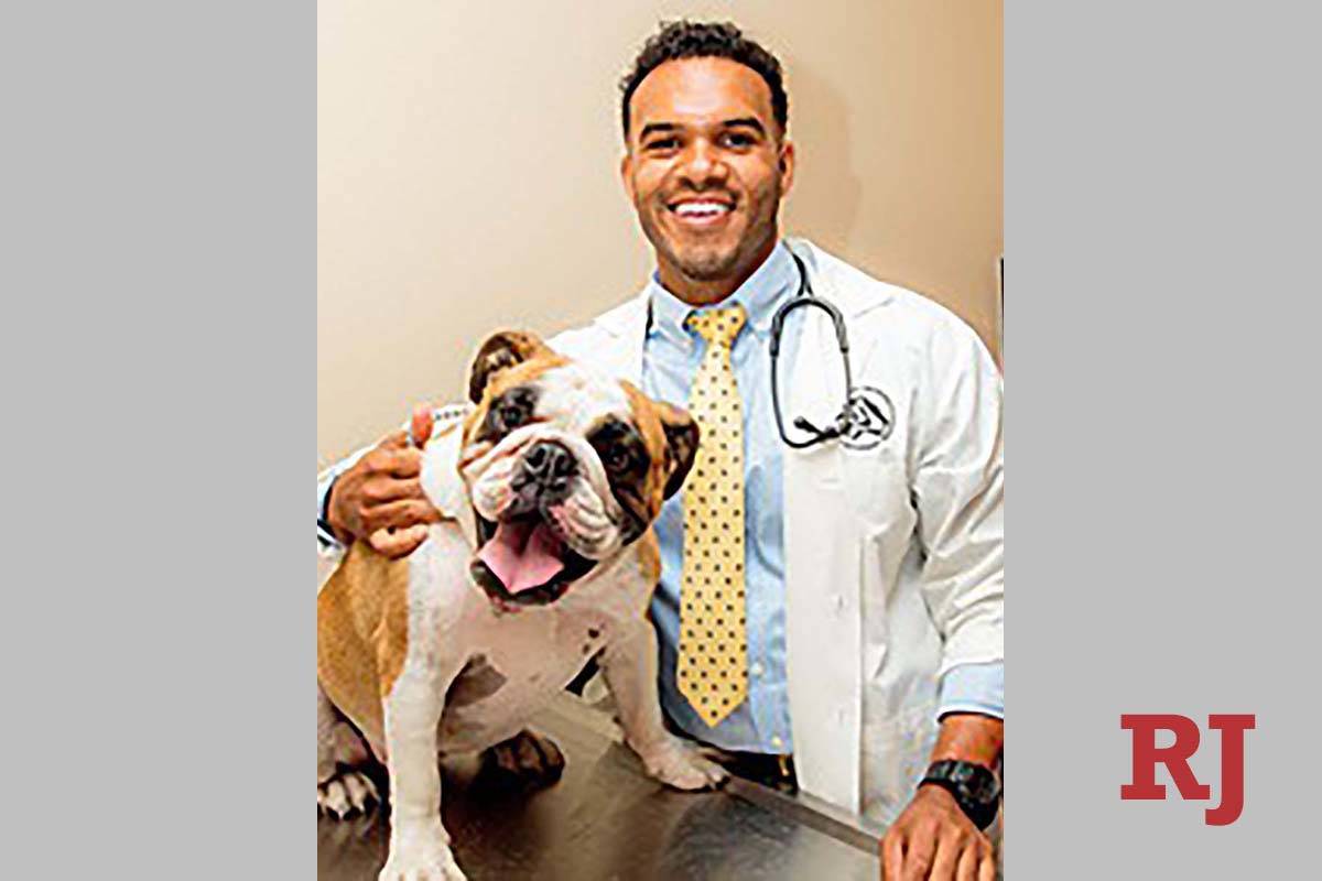 Dr. Aaron Bivens, a veterinarian at South Buffalo Springs Animal Hospital, with his English Bul ...