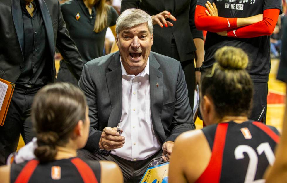 Las Vegas Aces head coach Bill Laimbeer talks up his players in a huddle during a timeout as th ...