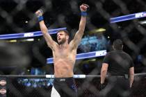 Calvin Kattar, left, celebrates after defeating Andre Fili in the featherweight bout during UFC ...