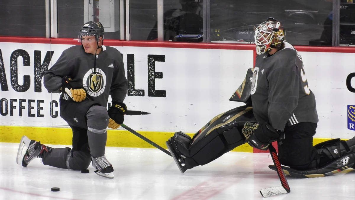 Vegas Golden Knights defenseman Nate Schmidt (88) talks with backup goaltender Robin Lehner (90 ...