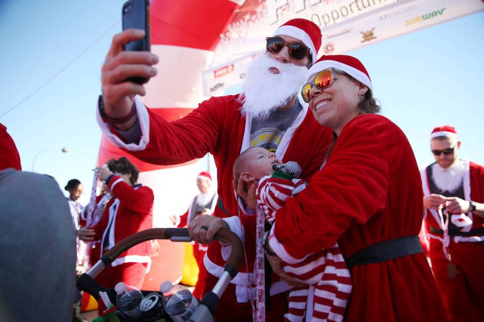 Casey Turner, left, with his wife Joanne and 7-week-old son Dillon, at finish line of the 14th ...