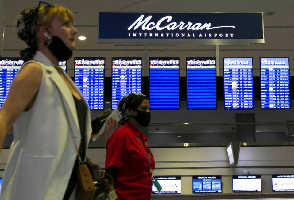 Arriving passengers walk past McCarran International Airport sign on Wednesday, June 24, 2020, ...