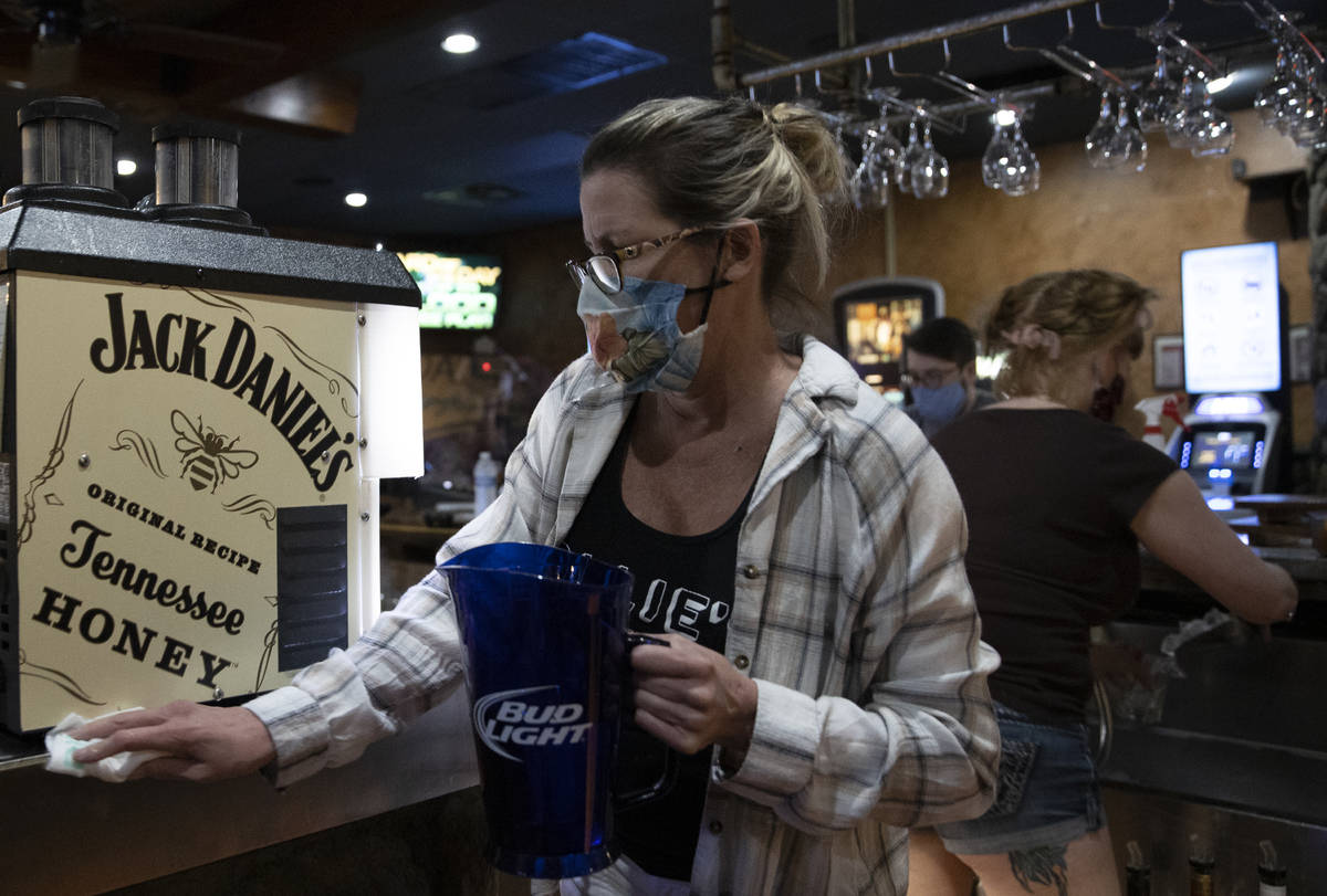 Bartender Dawn Smith wipes down the bar after last call at Jacksonճ Bar & Grill on Fr ...