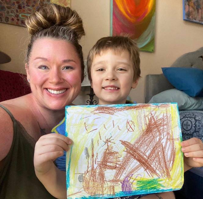 Christina Bentheim is pictured with her 5-year-old son, Artie, who's holding up a picture story ...
