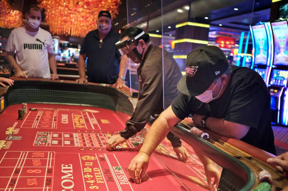 Craps players and dealers are seperated by partitions at the Golden Nugget Casino in Atlantic C ...