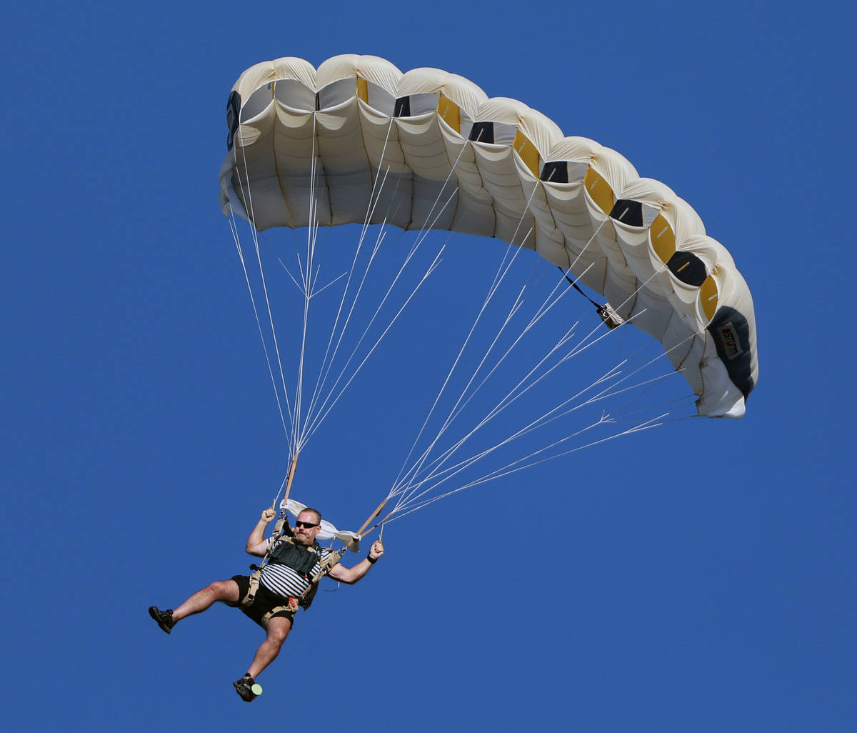 Skydivers descend for Marché Bacchus' Bastille Day celebration in front of the restaurant's gu ...