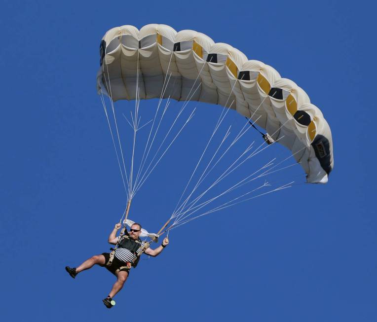 Skydivers descend for Marché Bacchus' Bastille Day celebration in front of the restaurant's gu ...