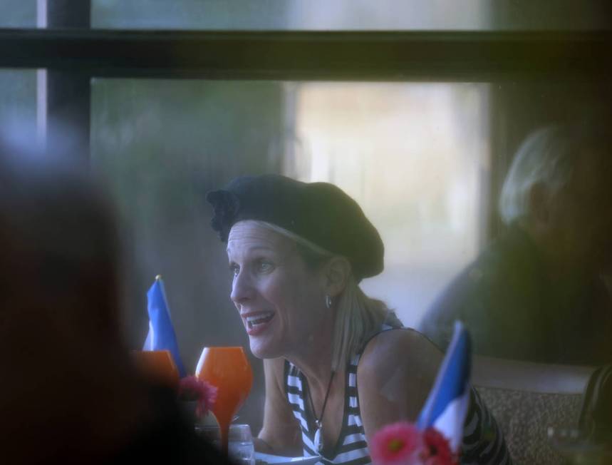 Scherri McHahon of Las Vegas dines at Marché Bacchus during a Bastille Day celebration, in Las ...