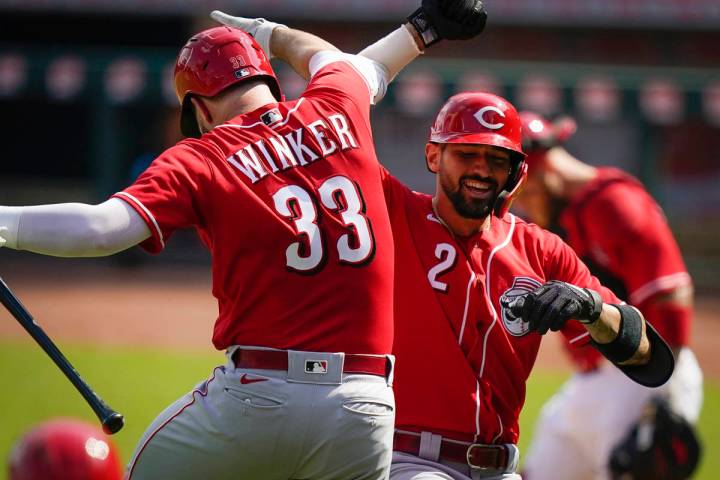 Cincinnati Reds Nick Castellanos (2) elbow-bumps Jesse Winkler (33) after hitting a two-run hom ...