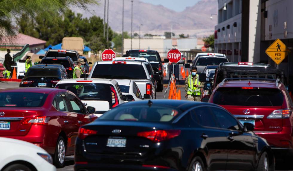 People line up for a coronavirus testing site at Texas Station in Las Vegas on Thursday, July 1 ...