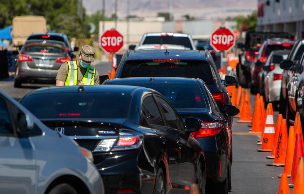 People line up for a coronavirus testing site at Texas Station in Las Vegas on Thursday, July 1 ...