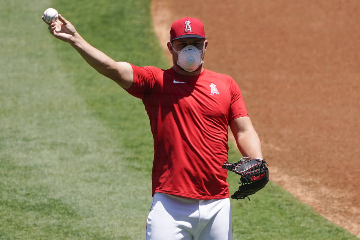 Los Angeles Angels center fielder Mike Trout throws a ball during baseball practice at Angels S ...