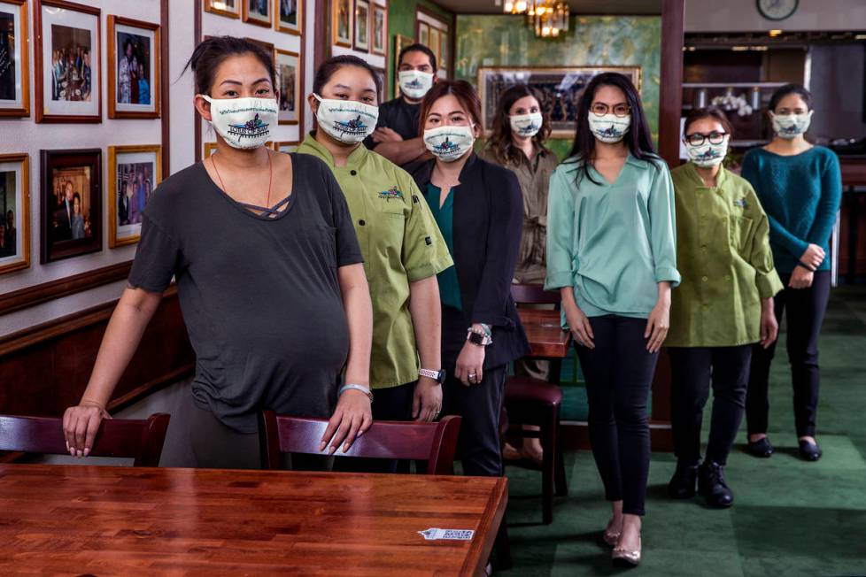 Penny Chutima, left, and sister Sabrina, behind her, joined by other staff members at Lotus of ...