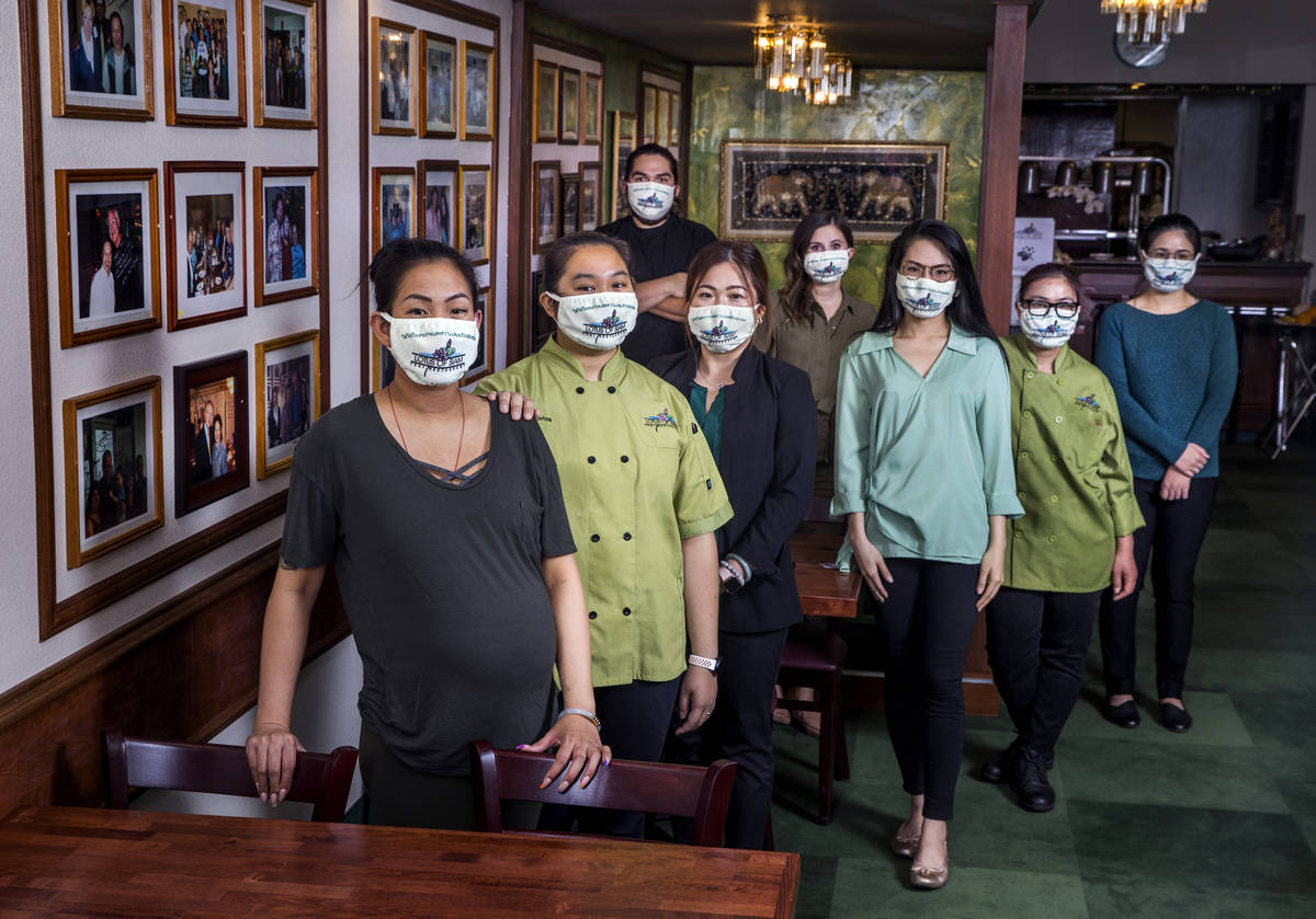 Penny Chutima, left, and sister Sabrina, behind her, joined by other staff members at Lotus of ...