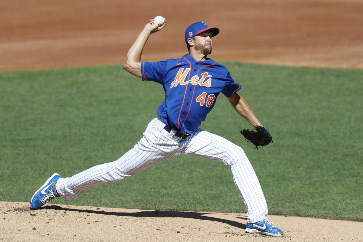 New York Mets starting pitcher Jacob deGrom winds up before delivering a pitch during a simulat ...