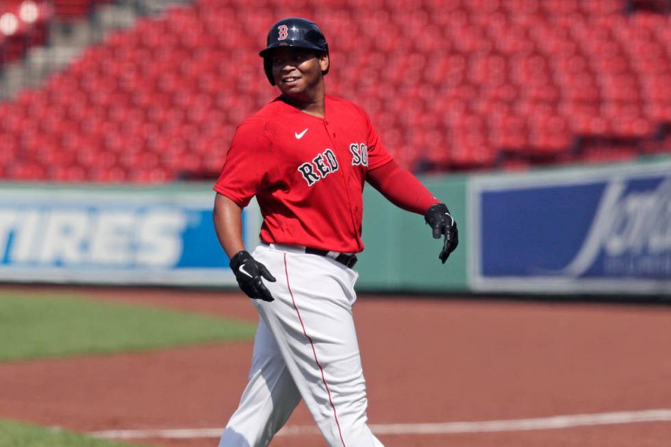 Boston Red Sox's Rafael Devers heads to the dugout after hitting a double during an intra-squad ...