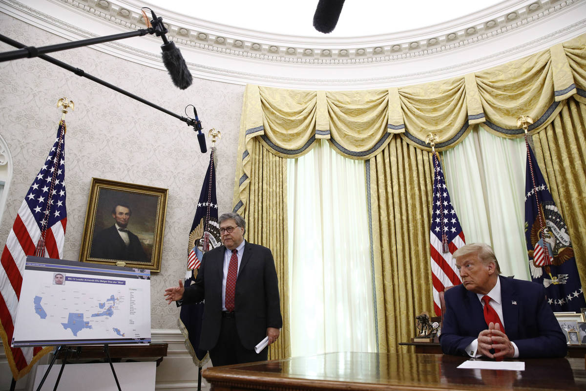 Attorney General William Barr, left, speaks during a law enforcement briefing on the MS-13 gang ...