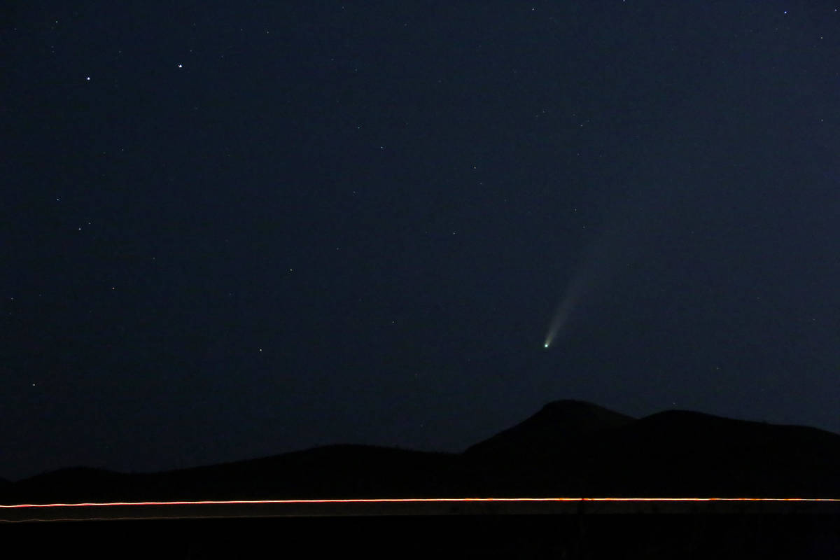 The 3-mile-wide Comet NEOWISE appears just above the horizon and Interstate 15 in the evening s ...