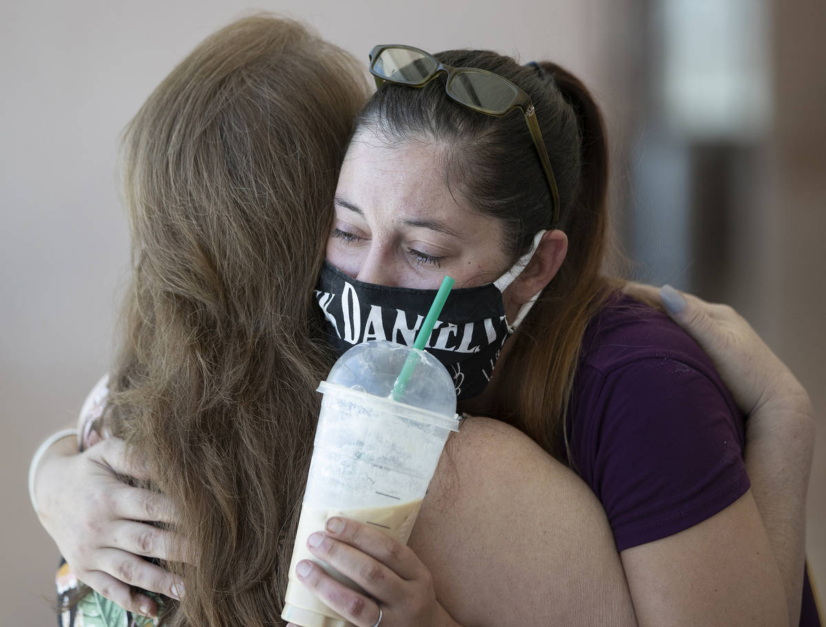 Jamie Henderson, right/facing, hugs Theresa Christensen at the conclusion of sentencing for Ray ...