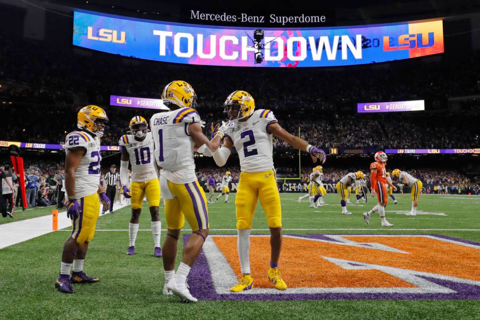 LSU wide receiver Ja'Marr Chase (1) celebrates after scoring with wide receiver Justin Jefferso ...