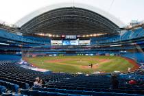 Photographers cover the game in an empty stadium during fourth-inning intrasquad baseball game ...