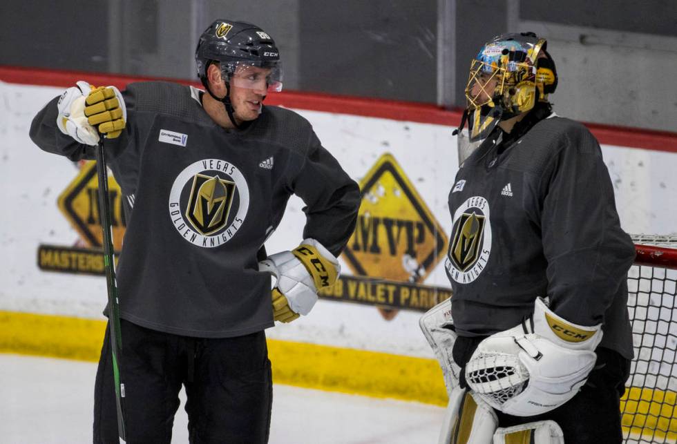 Vegas Golden Knights defenseman Nate Schmidt chats with goaltender Marc-Andre Fleury (29) durin ...