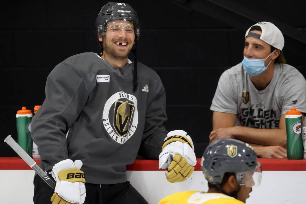 Vegas Golden Knights defenseman Shea Theodore (27), left, talks to Vegas Golden Knights goalten ...