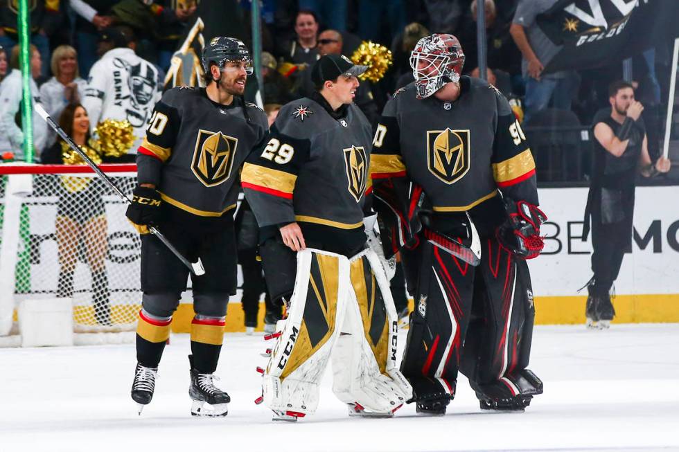 Golden Knights goaltenders Marc-Andre Fleury (29) and Robin Lehner (90) talk alongside Chandler ...