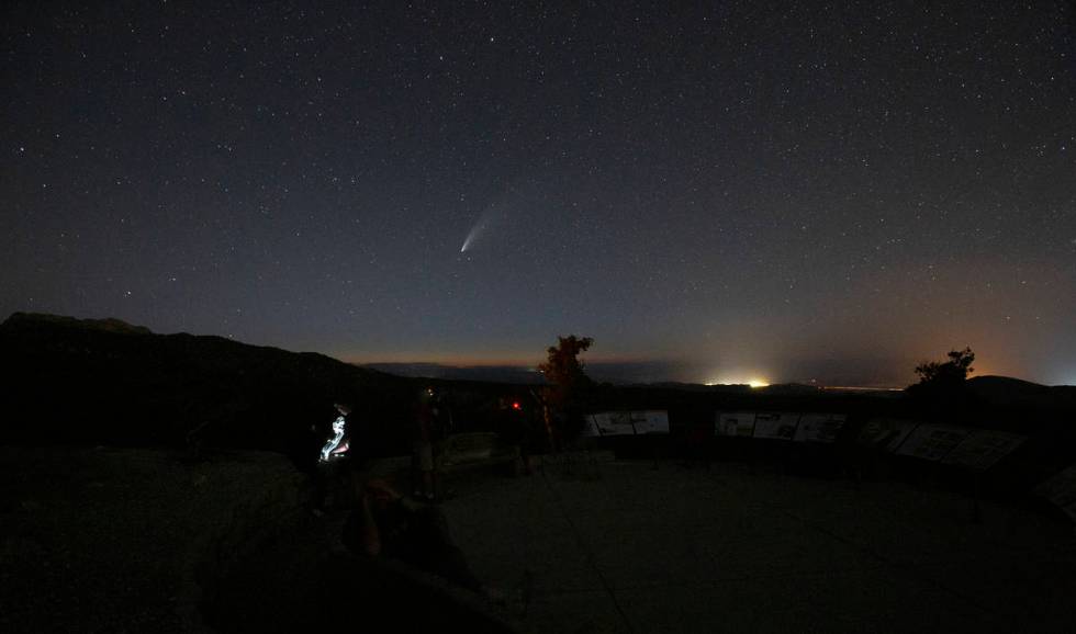 Viewers of the NEOWISE comet watch as it is visible to the naked eye for the last evening on Sa ...